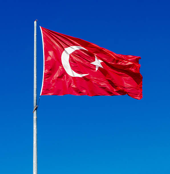 istock Waving flag of Turkey over blue sky background 472008139