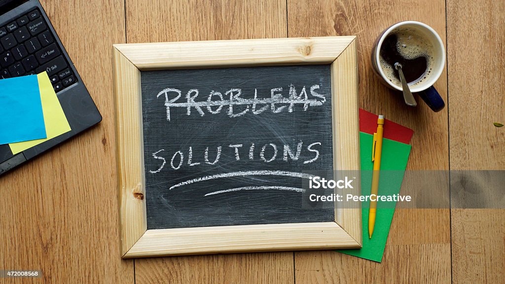 Solutions written Solutions written on a chalkboard at the office 2015 Stock Photo