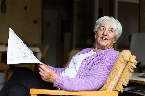 istock Senior woman reading morning newspaper 472010374