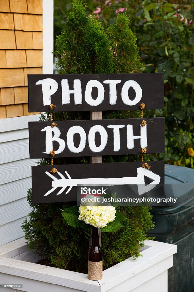 Photo Booth Wedding Sign A handmade sign reads photo booth with an arrow pointing the wedding guests to the photobooth location. Arrow Symbol Stock Photo