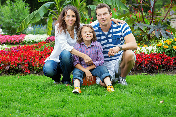 family in park with flowers stock photo