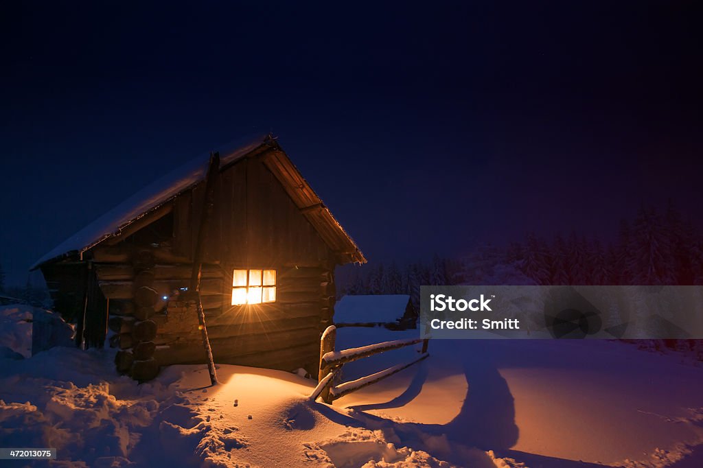 house wooden house in winter forest Blizzard Stock Photo