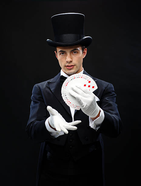 istock magician showing trick with playing cards 472013493