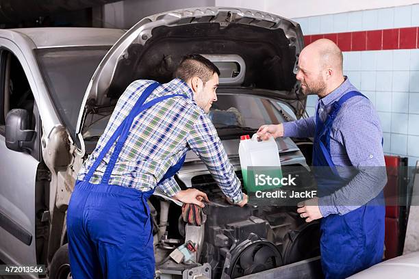 Mounting Specialists In Coveralls Working Stock Photo - Download Image Now - 2015, 35-39 Years, Adult