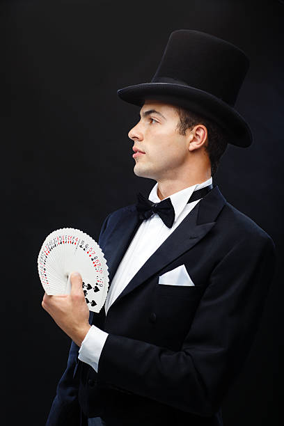 istock magician showing trick with playing cards 472013663