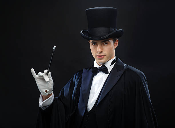 istock magician in top hat with magic wand showing trick 472013743