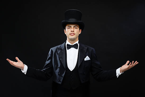 magician in top hat showing trick magic, performance, circus, show concept - magician in top hat showing trick tail coat photos stock pictures, royalty-free photos & images