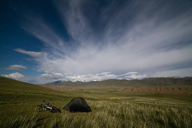 Tent in mountains under star sky stock photo