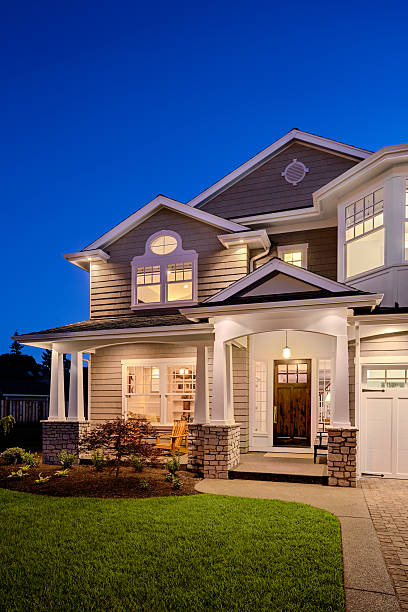 Beautifully landscaped custom dream home with circular concrete and brick driveway.