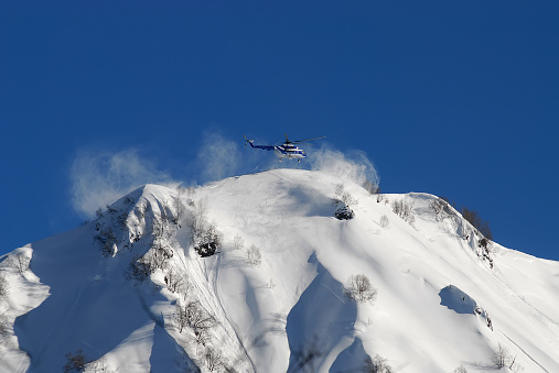 Snow capped mountains and helicopter