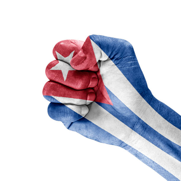 Flag Cuba on hand with clenched fist gesture over white background.