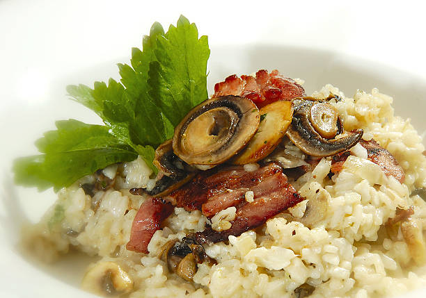Italian risotto Italian risotto w grilled mushrooms and bacon Cepe stock pictures, royalty-free photos & images