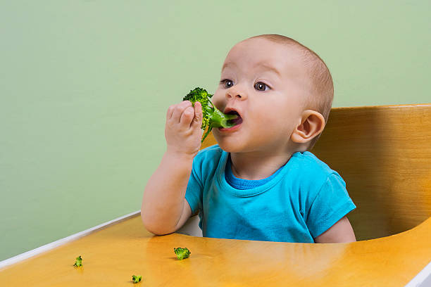 istock funny baby eating broccoli 472020964