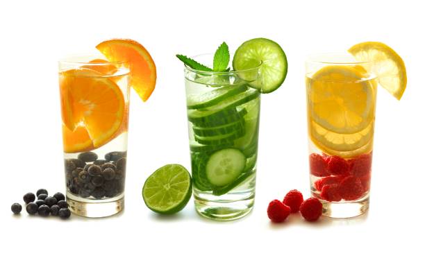 Detox water with fruit isolated on white Three types of detox water with fruit in glasses isolated on a white background infused water stock pictures, royalty-free photos & images