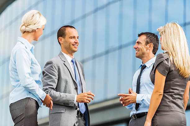 istock Four business people communicating outdoors. 472028473