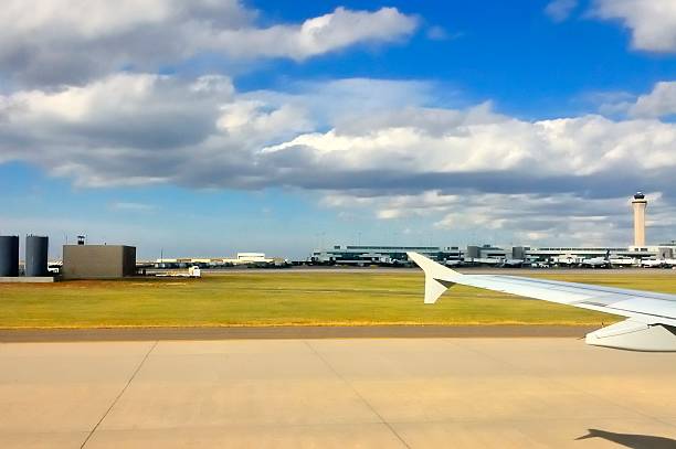 Truly a grab shot, the Denver International Airport from my seat in the airplane as we taxi to the terminal in the background with all the other airplanes lined up for boarding or unloading. The control tower and storage tanks add a nice touch, maybe.