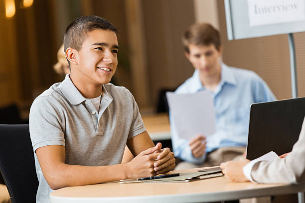 High school student being interviewd by college advisor or recruiter High school student being interviewd by college advisor or recruiter job fair photos stock pictures, royalty-free photos & images