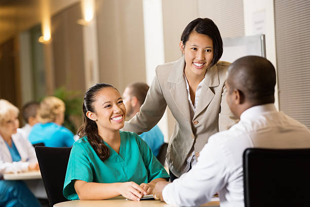 Hospital administrator interviewing nurse for potential employment Hospital administrator interviewing nurse for potential employment healthcare and medicine business hospital variation stock pictures, royalty-free photos & images