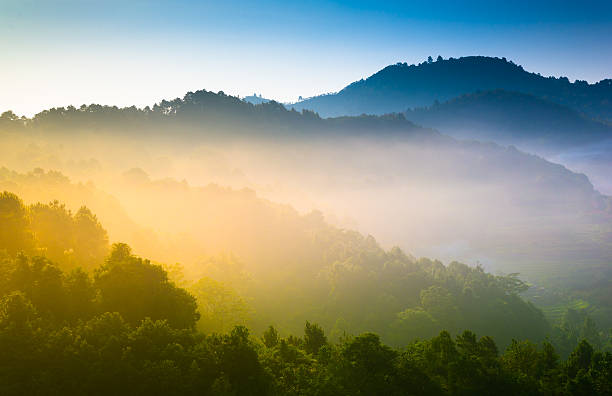 istock Beautiful sunshine at misty morning mountains . 472030125