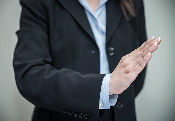 istock Woman signals denial with one hand 472030393
