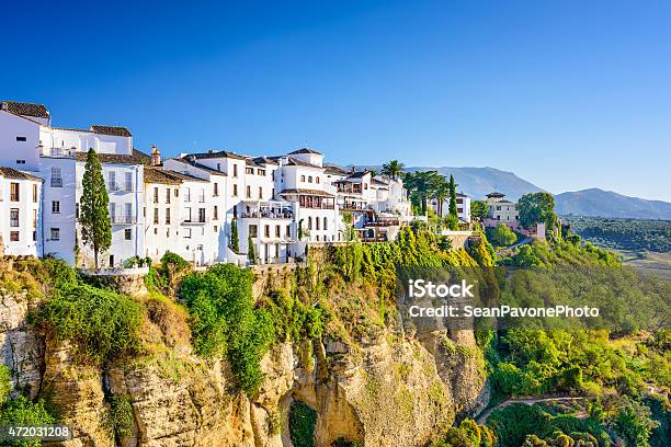 Houses On A Cliff In Ronda Spain Surrounded By Green Trees Stock Photo - Download Image Now