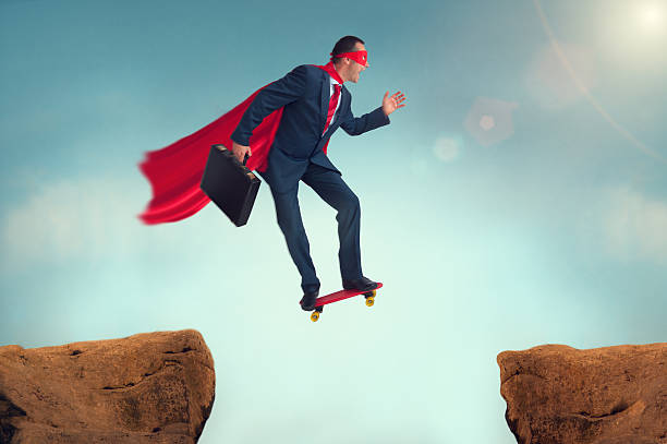 istock funny superhero businessman on a skateboard 472031288