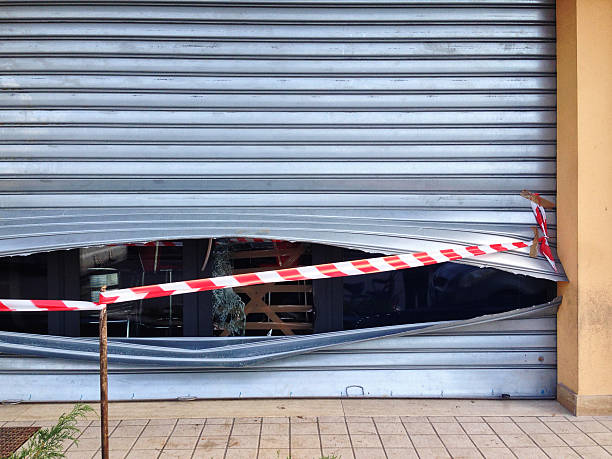 Rolling shutter smashed and shop robbed - Burglary stock photo