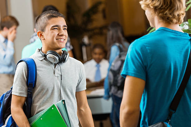 istock High school friends talking at college recruitment event 472031997