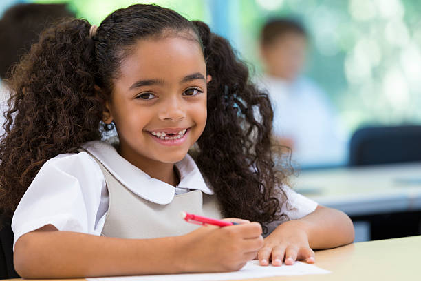 istock Adorable elementary age girl in private school wearing uniform 472033885