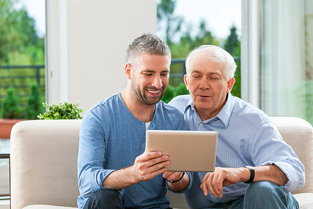 istock Father and adult son with digital tablet 472033907