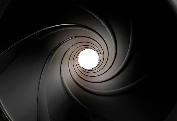 Photo of The view inside a gun barrel of the swirled grooves