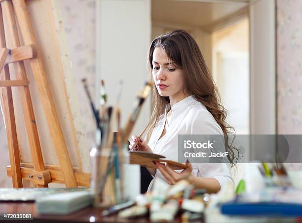 Longhaired Woman Paints On Canvas Stock Photo - Download Image Now - Adult, Adults Only, Art