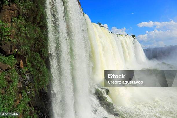 Powerful Iguacu Falls Under A Blue Sky Brazil Argentina Stock Photo - Download Image Now