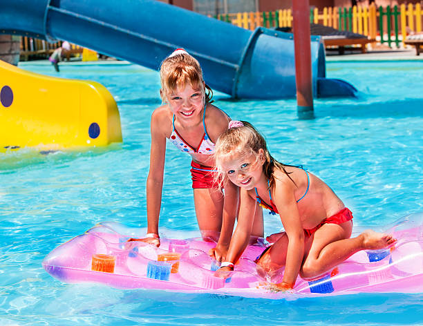 istock Child on water slide at aquapark 472035606