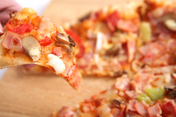istock Pizza ham and mushroom isolated in white background 472035687