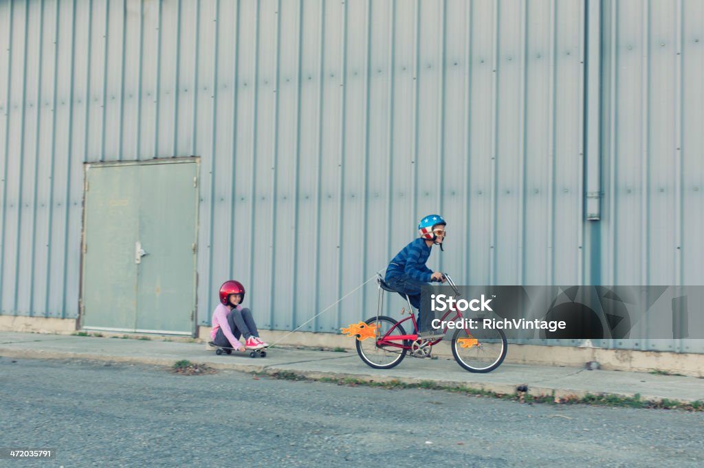 Sibling Fun A brother and sister come up with a unique way to experience speed.  Child Stock Photo