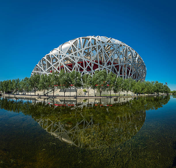 Beijing Bird's Nest Olympic National Stadium reflecting in lake China Beijing, China - 25th September 2013: The iconic steel lattice of Beijing's National Stadium, or Bird's Nest, reflecting in the tranquil waters of Olympic Park lake in the heart of China's vibrant capital city. beijing olympic stadium photos stock pictures, royalty-free photos & images