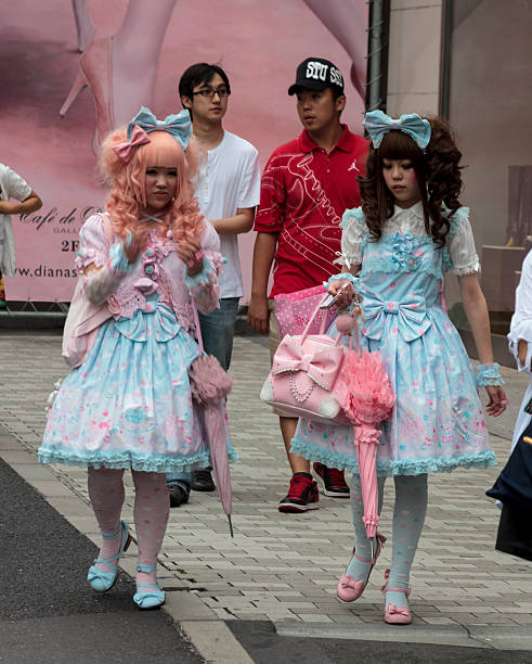 Gothic lolitas walking in the street stock photo