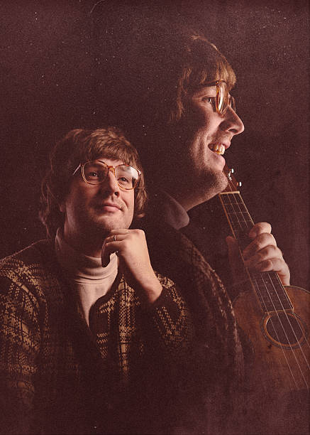 Faded Glamour Shot Yearbook Photo A vintage man 1970's - 1980's style poses for a high school portrait, his face mirrored on the side holding his prized ukelele with an awkward expression.  Retro-styled; INTENTIONAL DEGRADATION OF IMAGE AND LIGHTING. high school photos stock pictures, royalty-free photos & images