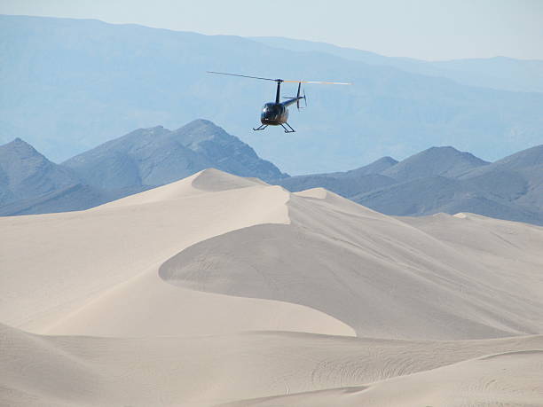 Helicopter Flying over the Sand Dunes of Dumont Dunes stock photo