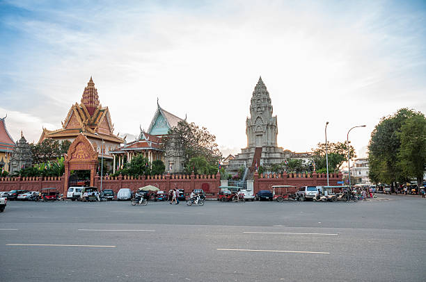 Phnom Penh, Сambodia - November 24, 2013: Traffic in front of Wat Ounalom In the river front area of Phnom Penh, Cambodia. The river front in Phnom Penh is a fast developing tourist area with many hotels, restaurants, bars and new developments being built around the ancient Palace and Temple
