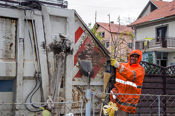 Man On A Garbage Truck Belgrade, Serbia - 23. november 2013. scuttle stock pictures, royalty-free photos & images