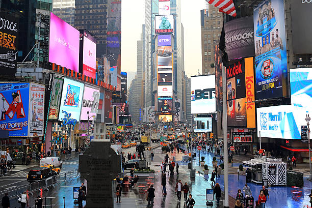New York City: Christmas New York City, United States - December 4, 2012: Times Squre of New York City in the rain with visitors and tourists everywhere times square new years eve stock pictures, royalty-free photos & images