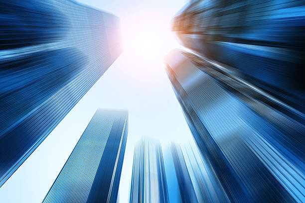 istock low angle view of modern skyscraper in blur motion 472041930
