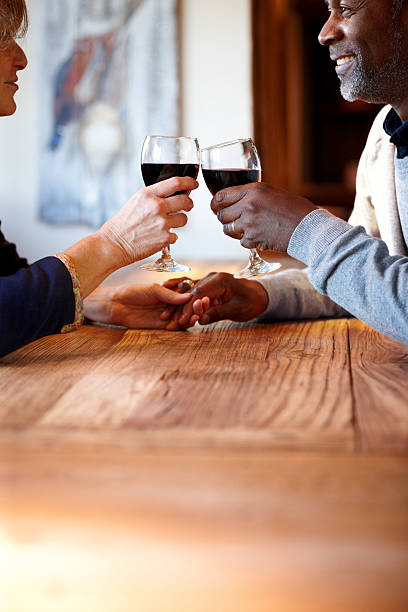 istock Mature couple celebrating with wine in pub 472042077