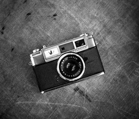 Antalya, Turkey - November 1, 2013: Product shot of a Yashica J analog SLR camera with 50mm lens attached on wooden background