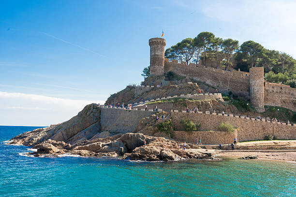 Beach and medieval castle in Tossa de Mar, Spain Tossa de Mar, Spain - October 13: Tourist at the beach and medieval castle in Tossa de Mar, Catalonia, Spain, Costa Brava on October 13, 2013. tossa de mar stock pictures, royalty-free photos & images