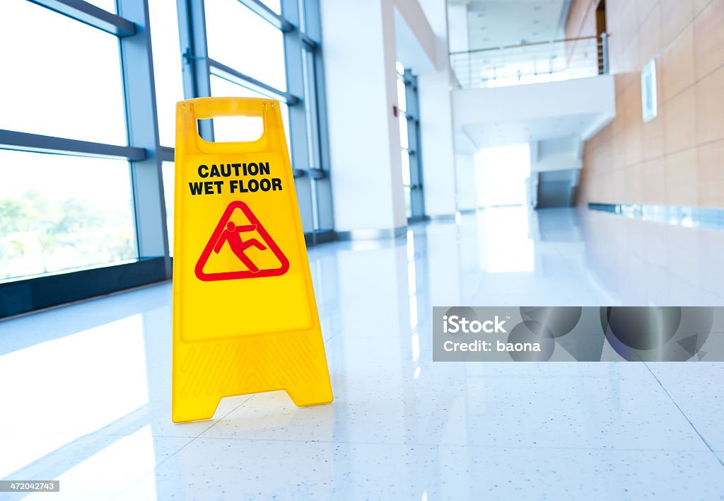 warning sign slippery Yellow sign on floor that alerts for wet floor. Falling Stock Photo