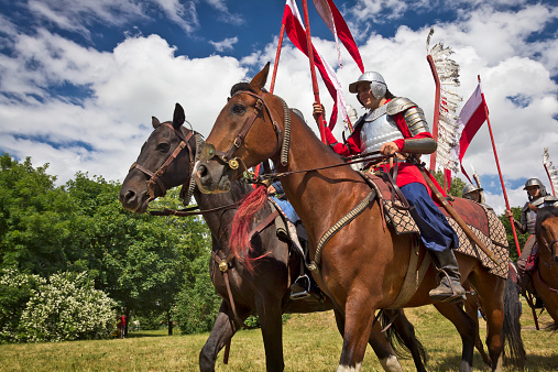 Stargard, Poland - June 23, 2013:Reenactors dressed as hussars exercise horse riding in the meadow.The Polish Hussars were the main type of cavalry of the first Polish Army between the 16th and 18th centuries