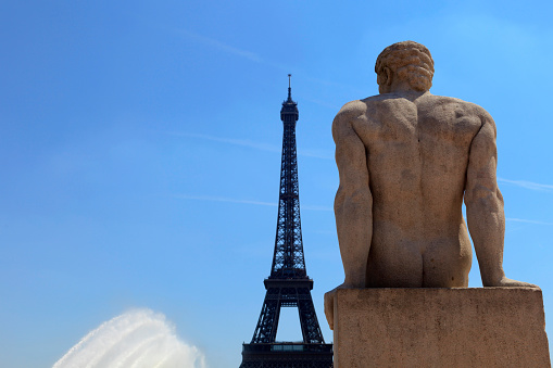 Paris, France - June 7, 2013; statue L'Homme (1937) by Pierre Traverse (1892-1979) at Trocadero with the Eiffel Tower in the background